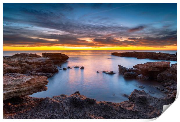 Beautiful sunrise over rocks at the beach at Torre de la Sal Print by Helen Hotson