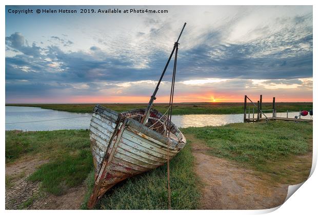 Sunrise over abandoned fishing boat on the shore a Print by Helen Hotson