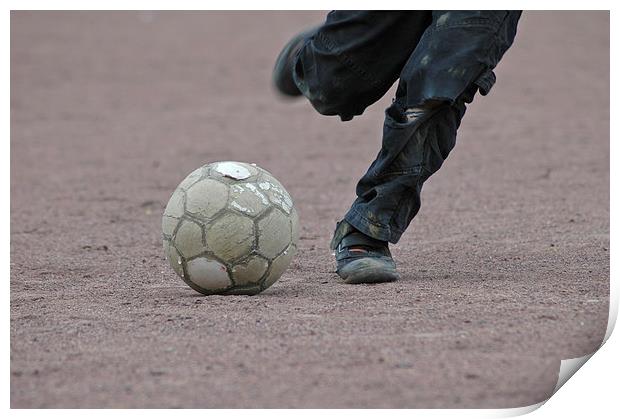Boy is kicking a football Print by Matthias Hauser