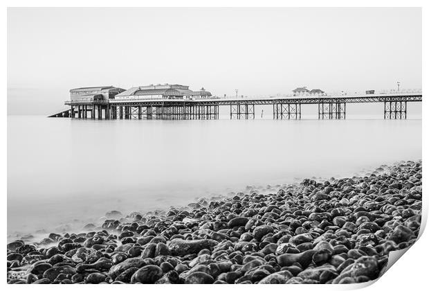 Cromer pier seen over the pebble beach in monochro Print by Jason Wells