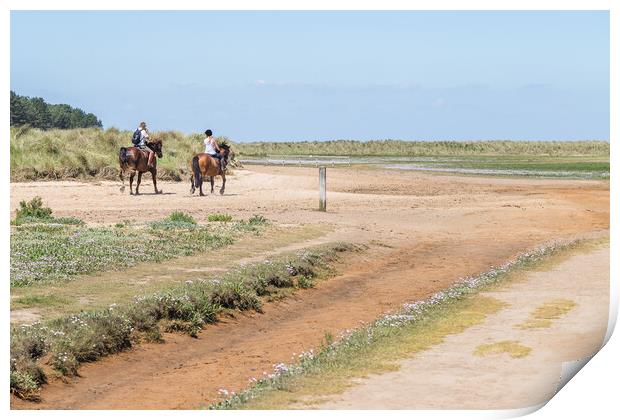 Couple riding horses on Holkham beach Print by Jason Wells