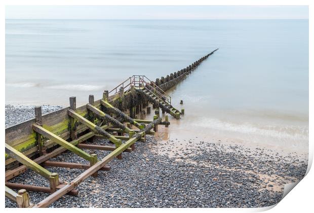 Wooden groyne stretching into the sea Print by Jason Wells