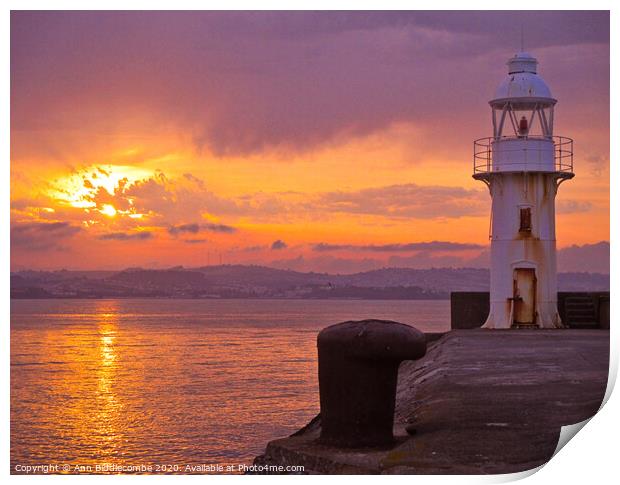Sunset over Brixham Lighthouse Print by Ann Biddlecombe