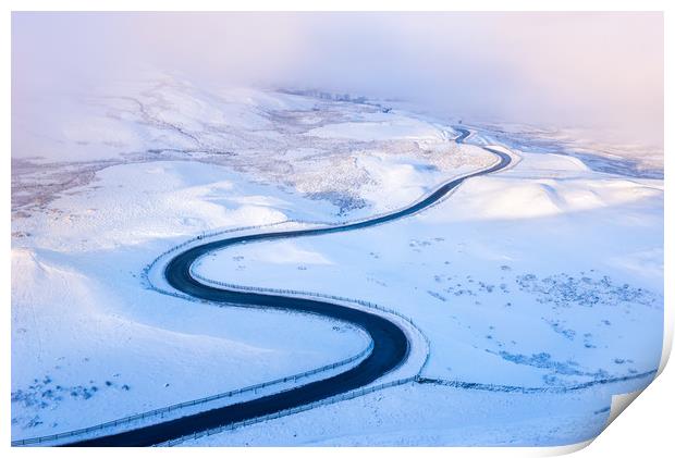 Bendy road through the snow Print by Andrew Kearton
