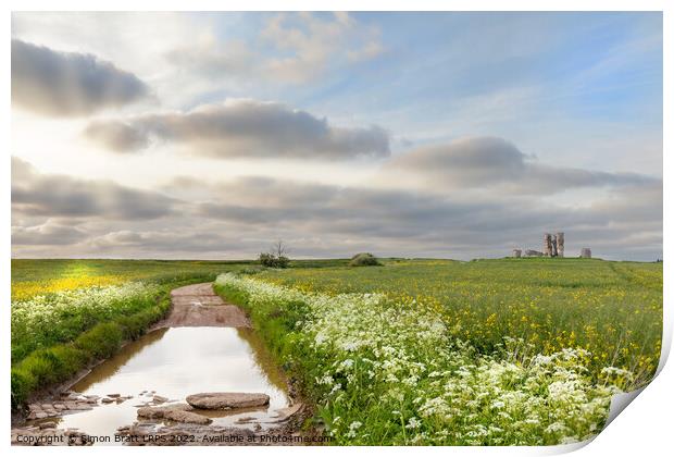 Flooded broken road leading to ruined Bawsey church Print by Simon Bratt LRPS