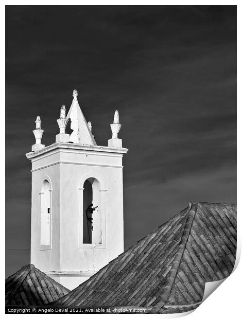 Church bell tower behind tiled roofs in Tavira Print by Angelo DeVal