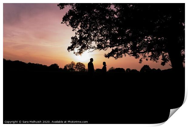 Two people standing under a tree in front of a sunset Print by Sara Melhuish