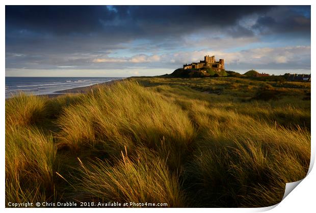 Bamburgh Castle at sunset   Print by Chris Drabble