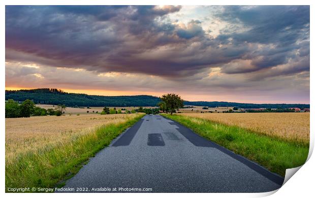 Road in rye fields. Summer evening. Sunset sky. Print by Sergey Fedoskin