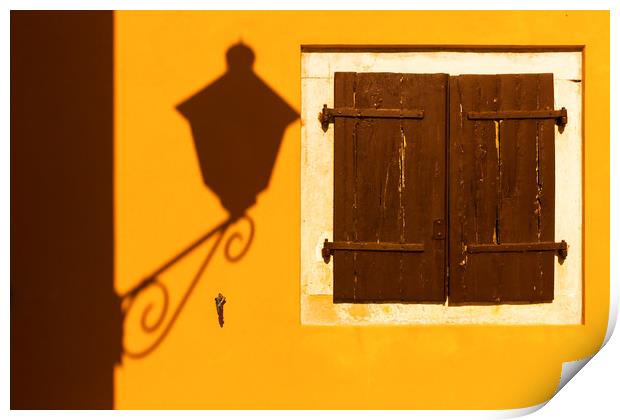Street lamp shadow on a yellow wall. Print by Tartalja 