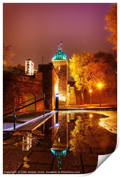 The Porte St Louis, Quebec City, at night reflected in a puddle of water Print by Colin Woods