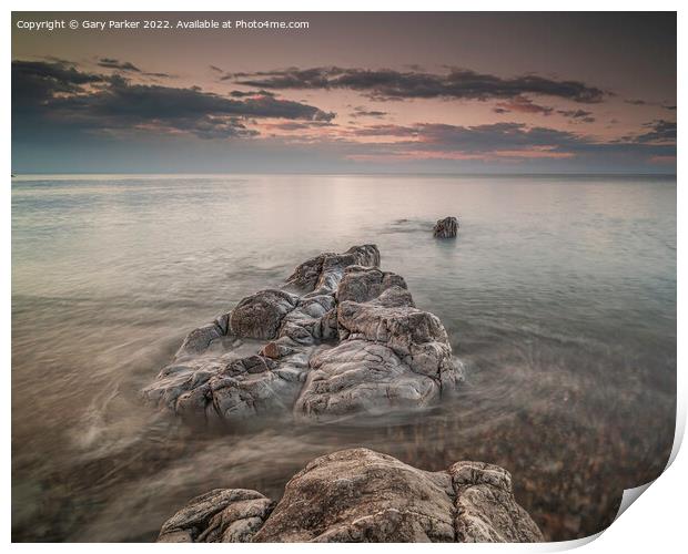 Long exposure on shoreline rocks Print by Gary Parker