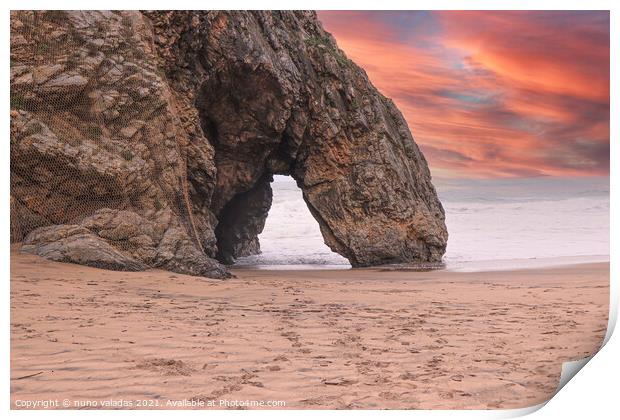 Beautiful stone natural arche. Rock formation in a beach with ocean in background at the sunset Print by nuno valadas