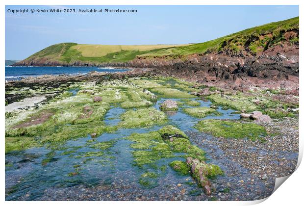 Mossy rocks on edge of Manorbier beach Pembrokeshire Print by Kevin White