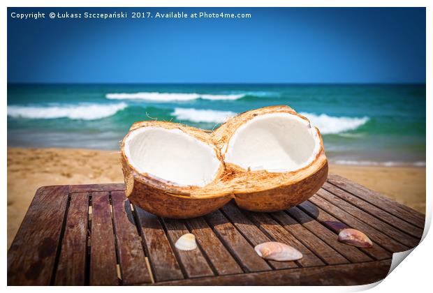 Coconut on the table against beautiful beach Print by Łukasz Szczepański