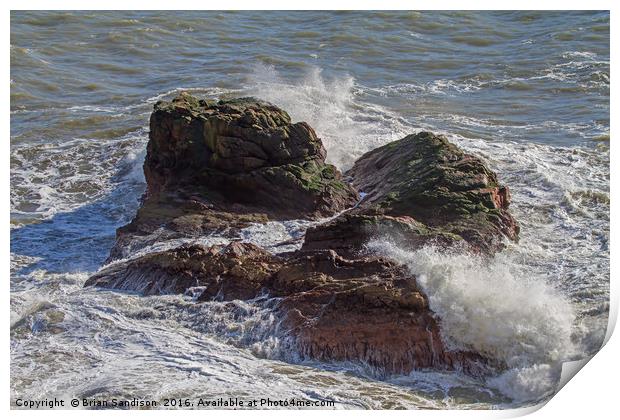 A Heavy Sea smashes the exposed rocks Print by Brian Sandison