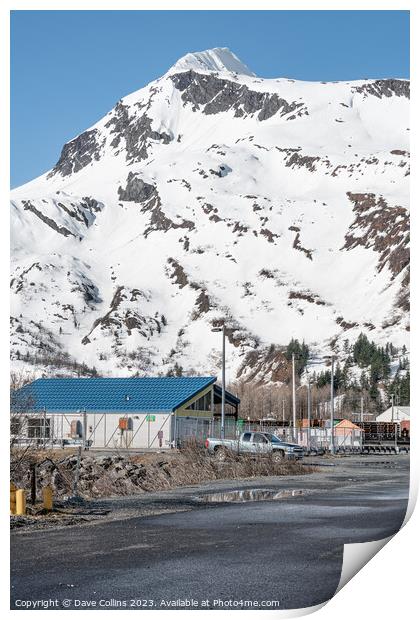 Industrial buildings in the town with snow a covered mountain in the background, Whittier, Alaska, USA Print by Dave Collins