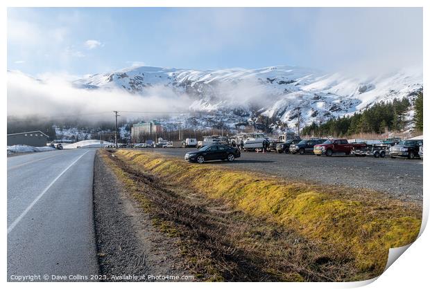 The main car and boat trailer parking area in Whittier with the  Begich Towers Condominium building and fog and snow mountains , Whittier, Alaska, USA Print by Dave Collins