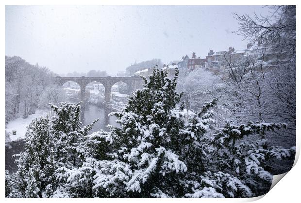 Winter snow over the river Nidd and famous landmark railway viaduct in Knaresborough, North Yorkshire. Print by mike morley