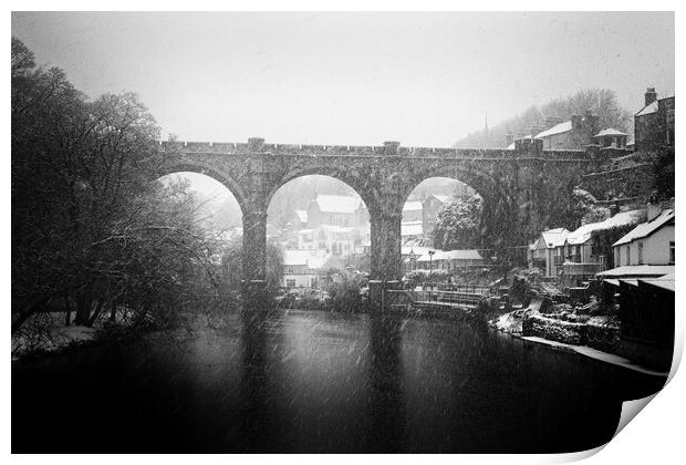 Winter snow over the river Nidd and famous landmark railway viaduct in Knaresborough, North Yorkshire. Print by mike morley