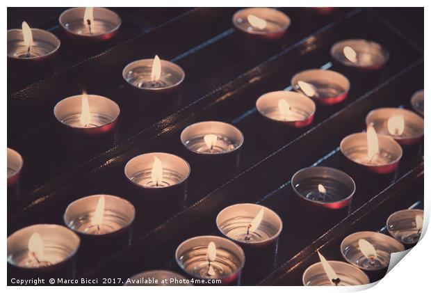 Rows of brightly burning votive candles Print by Marco Bicci