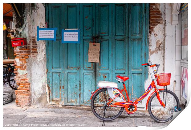 Red bicycle parked by blue doors Print by Kevin Hellon
