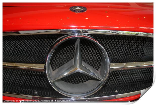 Mercedes badge on a red car. Print by Kevin Hellon