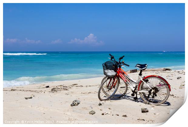 Bicycles on a white sand beach Print by Kevin Hellon