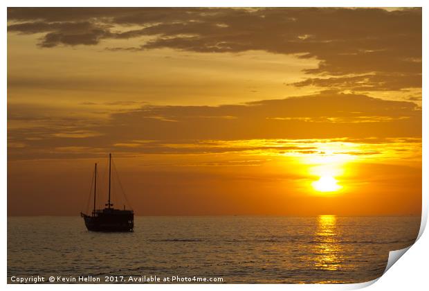 Boat silhouette at sunset Print by Kevin Hellon