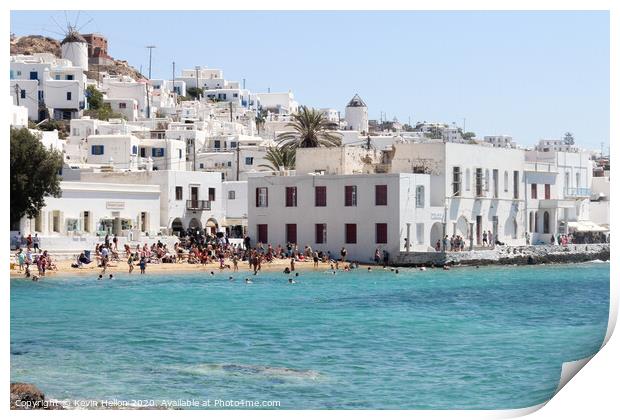 Tourists relaxing on the beach in Chora, Mykonos,  Print by Kevin Hellon
