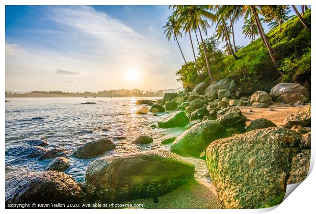 Tropical sunrise over rocks Print by Kevin Hellon