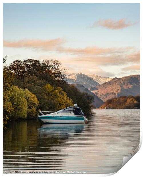 Landscape image of boat moored on Ullswater in Lake District with snowcapped mountains in background with beautiful vibrant Autumn Fall colors Print by Matthew Gibson