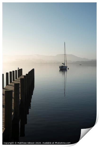 Stunning unplugged fine art landscape image of sailing yacht sitting still in calm lake water in Lake District during peaceful misty Autumn Fall sunrise Print by Matthew Gibson
