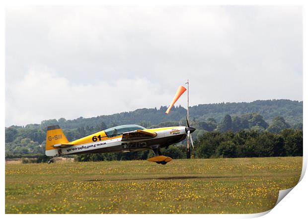 Extra 300 aerobatic plane lnding Print by Chris Day