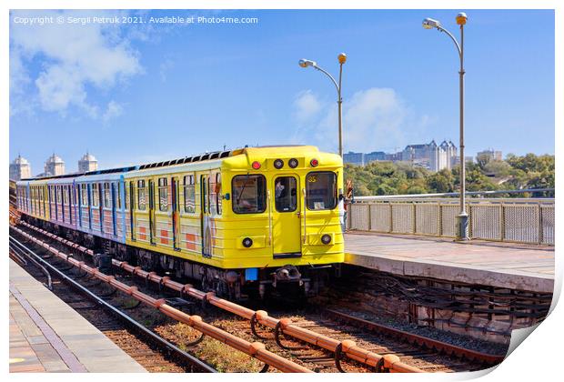 A bright yellow metro train departs from the platform and rushes along the metro bridge in Kyiv to the left side of the city. Print by Sergii Petruk