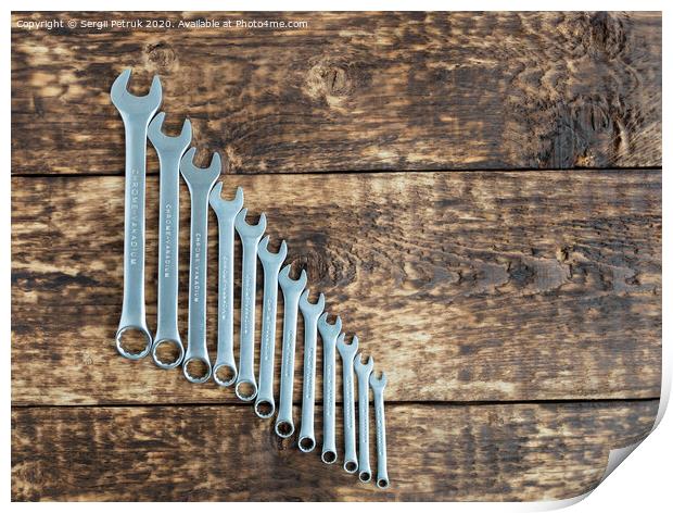 set of wrench against old wooden boards background Print by Sergii Petruk