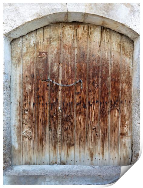 Ancient trapezoidal antique wooden doors with a metal lock in the middle Print by Sergii Petruk