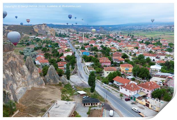 Dozens of balloons fly over the valleys in Cappadocia Print by Sergii Petruk