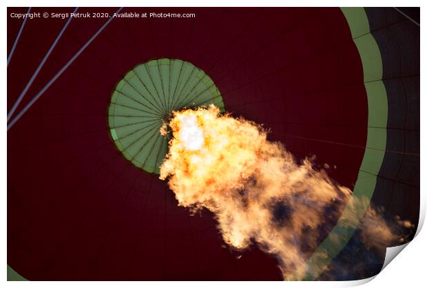 The flame of a gas burner inflates a balloon Print by Sergii Petruk