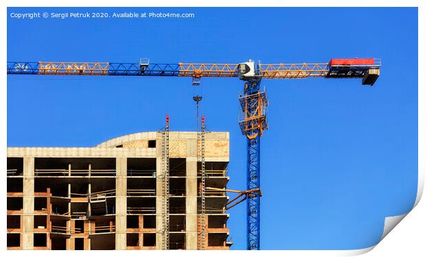 Facade and construction crane near the modern concrete building under construction. Print by Sergii Petruk