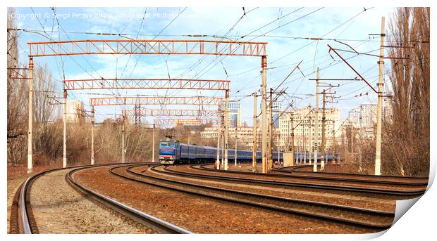 Passenger train cars of the train ride on the railway tracks in the background of the cityscape Print by Sergii Petruk
