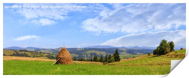 A haystack stands in a meadow against the backdrop of the Carpathian mountains and slopes. Print by Sergii Petruk