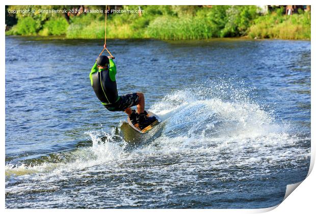 A wakeboarder rushes through the water at high speed along the green bank of the river. Print by Sergii Petruk