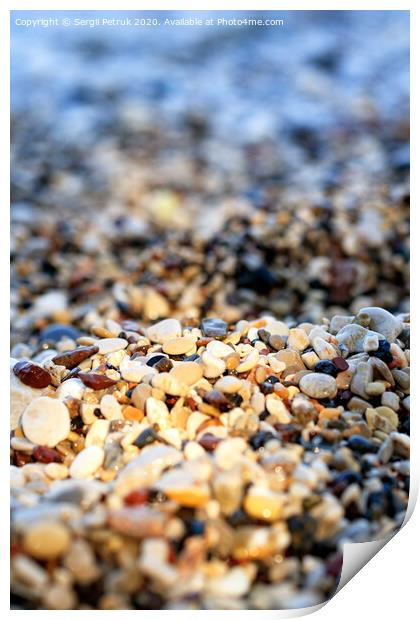 Beach pebbles backlit by a bright sunbeam. Print by Sergii Petruk