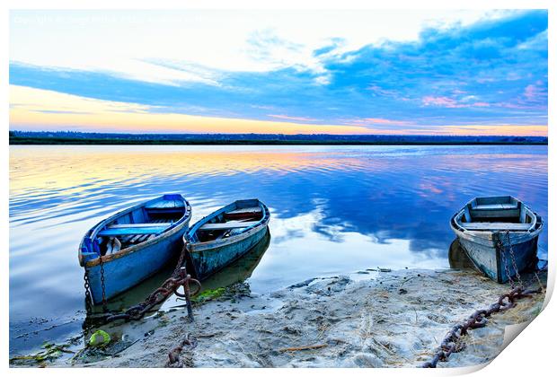 Old blue-green boats moored to the shore by old iron chains and stand on the shore of a calm river against the background of the morning horizon. Print by Sergii Petruk