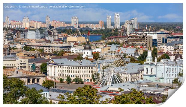 The landscape of the summer city of Kyiv overlooking the old district of Podil with a Ferris wheel and a bell tower with a gilded dome, the Dnipro River and many city buildings. Print by Sergii Petruk