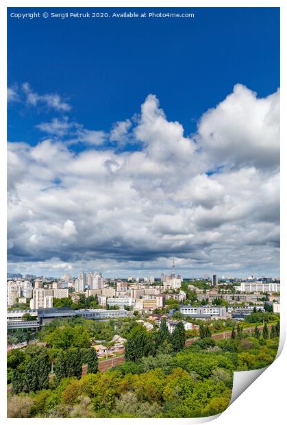 An urban landscape with a green park, residential areas and a TV tower against a bright blue sky with thickening clouds. Print by Sergii Petruk