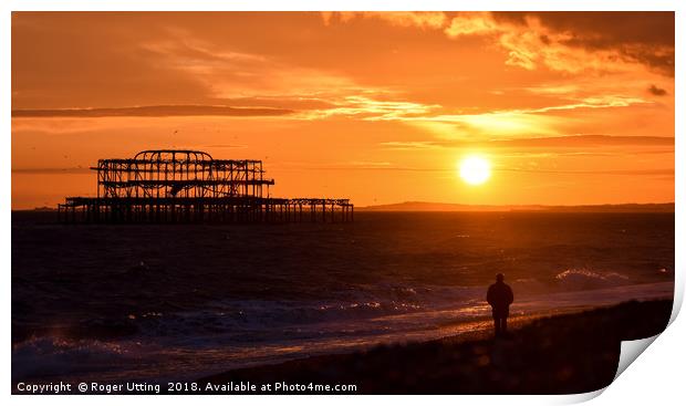 West pier sunset watcher Print by Roger Utting