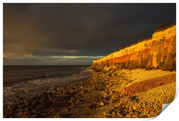 Hunstanton Cliffs at sunset with dark stormy sky Print by Andrew Michael