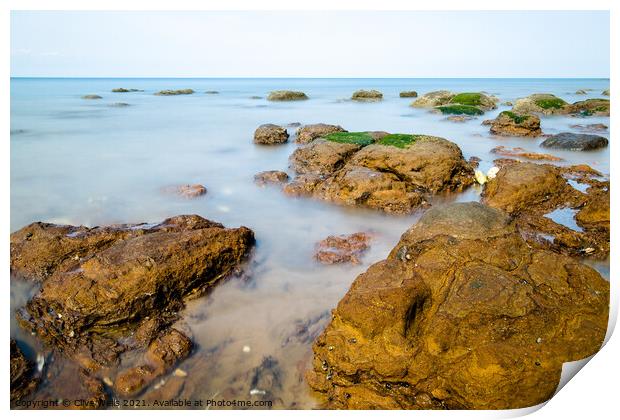 Rocks in the sea Print by Clive Wells